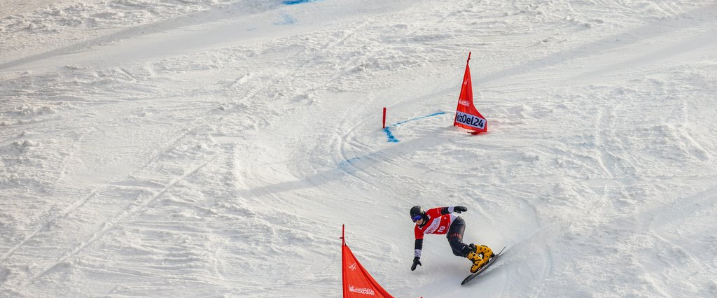 Ein Snowboardfahrer beim Slalom fahren.